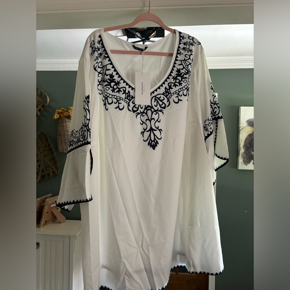 New white top with black pattern.